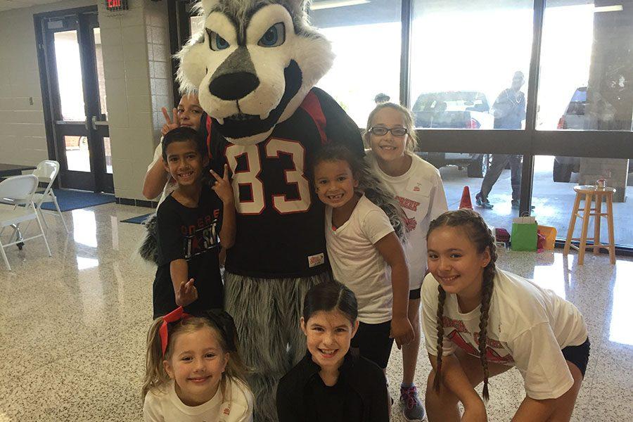 The mascot Daniel Ortiz stands with some of the kids at the cheer clinic.
