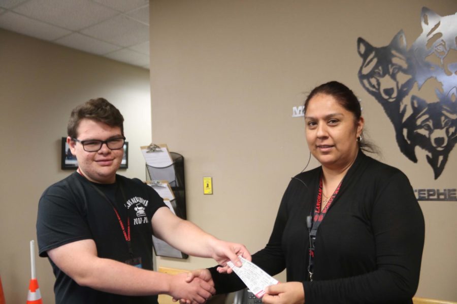 The lucky winner is AP Secretary Mrs Segundo, awarded her tickets by LCHowler Editor-in-Chief Connor Duskie.