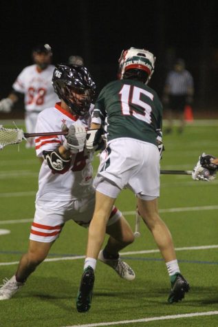 Sophomore Ryan Gosmano blocks a Woodlands player at a game on February 17th