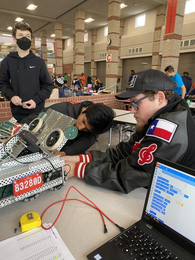 Jake Sanz and Isai Arteaga make some adjustments to their robot with alumni mentor Jace Criswell,  inspecting their work. The Halloween Madness contest took place on October 29th.  Both Langham teams had top 20 rankings, with our Langham Creek Rampage team making it to the playoffs.  Our other team is Langham Creek (L.C.) PowerPack.
