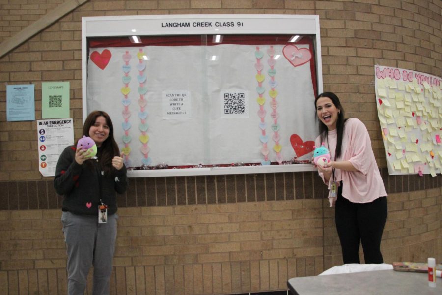 Newspaper staff decorates the cafeteria board in celebration of Valentines Day.