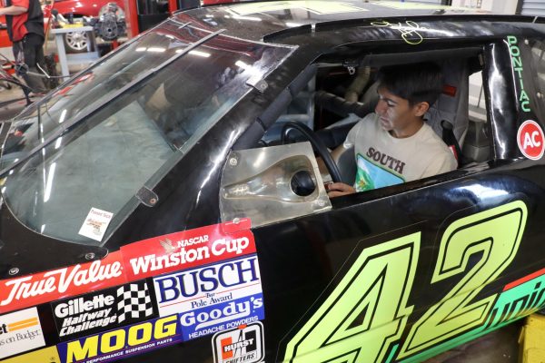 Nicolas Galicia,12th, works on a retired Mello Yello #42 Kyle Petty NASCAR during his afternoon block periods of Automotive Technology. The car was brought into the school shop by local Youtuber ‘Grassroots NASCAR’ who loaned it to the class for the students to gain experience working on a high performance sports car.