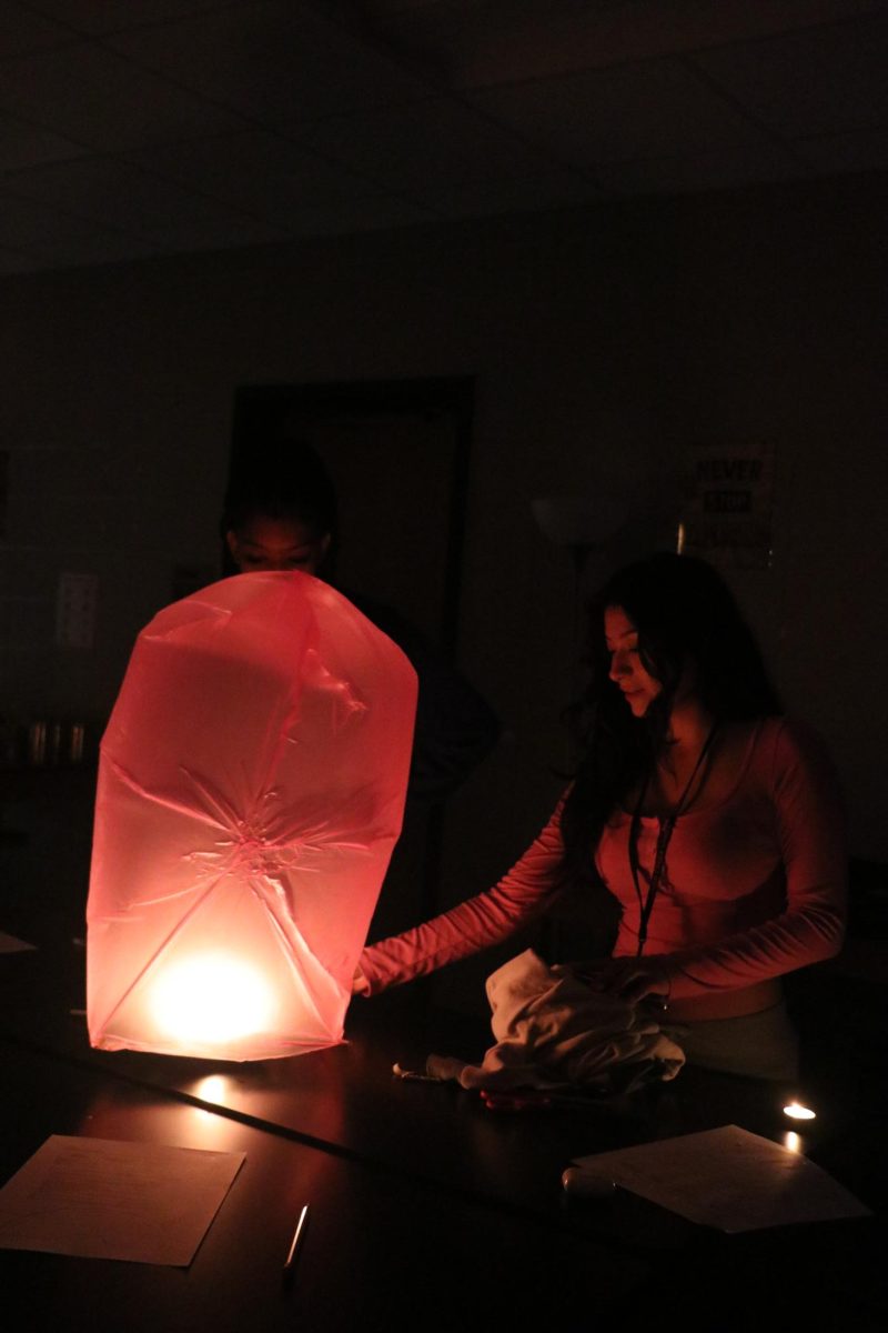 Alexandria Smith (12) and Melanie Lesperance (12) adding heat to their lantern to test convection currents and fulfill their goal of making the lantern float. 