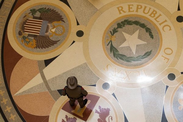 A state satnds at the Texas State Capitol rotunda prior to a Senate session where Republicans will attempt to pass a bill allowing the redistricting of the state's 38 congressional districts, in Austin, Texas, U.S. August 22, 2025. REUTERS/Nuri Vallbona