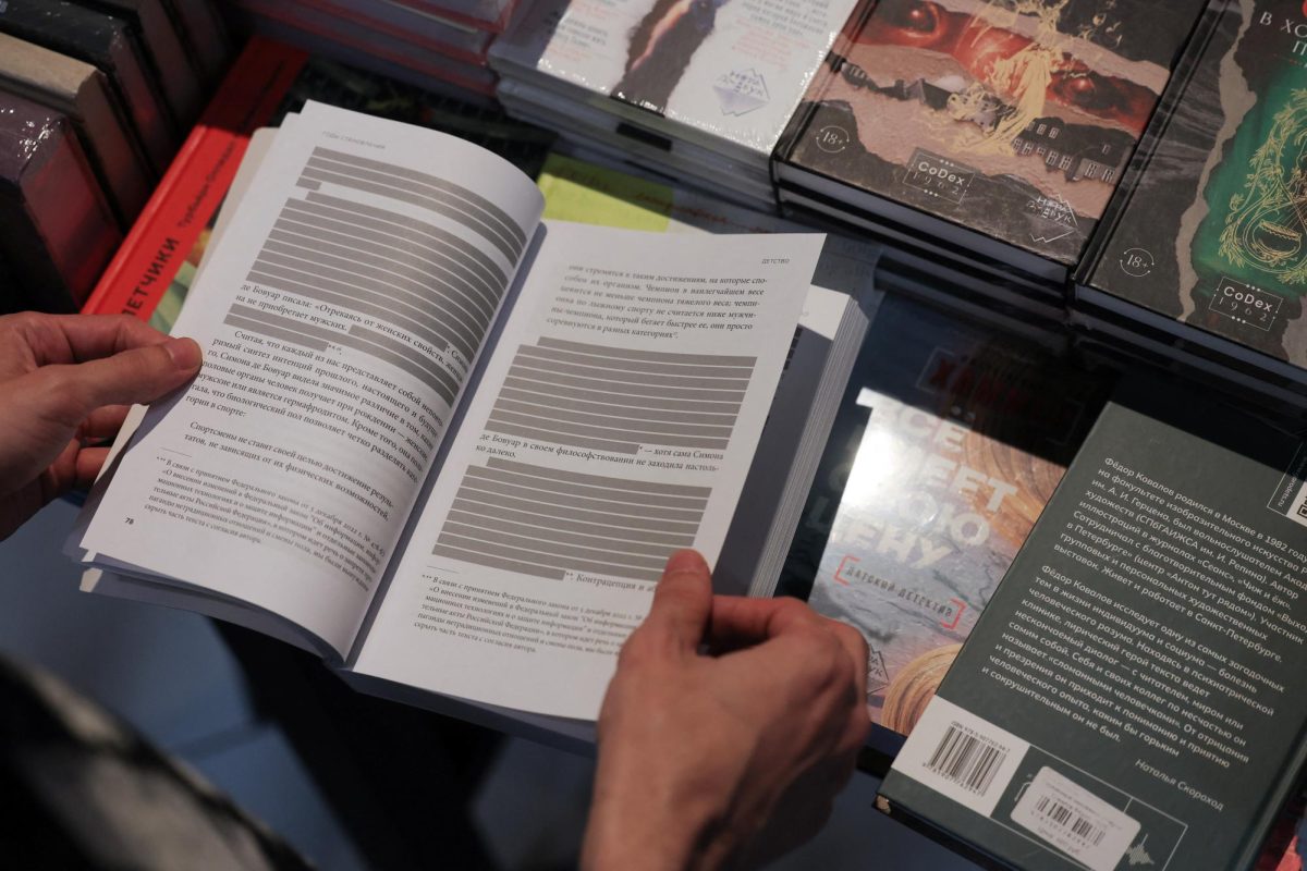 An employee shows the censored edition of the book "How to Be Authentic: Simone de Beauvoir and the Quest for Fulfillment" by Skye Cleary in the "Vo ves golos" (At the top of my voice) bookstore in Saint Petersburg, Russia September 1, 2025.  REUTERS/Anton Vaganov