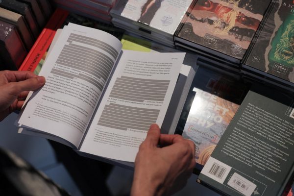 An employee shows the censored edition of the book "How to Be Authentic: Simone de Beauvoir and the Quest for Fulfillment" by Skye Cleary in the "Vo ves golos" (At the top of my voice) bookstore in Saint Petersburg, Russia September 1, 2025.  REUTERS/Anton Vaganov