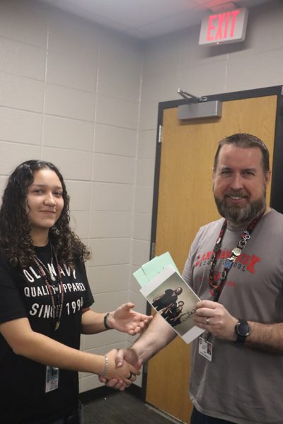 Junior Jennifer Luna Alvarado receives concert tickets from Mr Ricks on Monday to see the Crane Wives. Luna Alvarado won the tickets in a drawing for those students visiting and leaving comments on the LC Howler website.